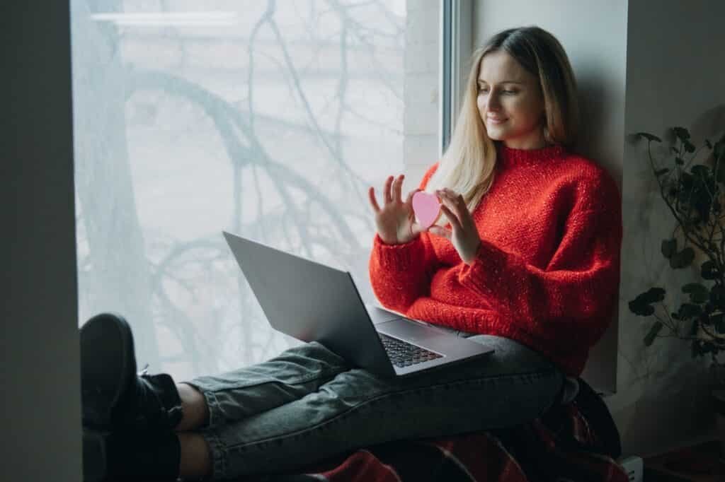 Woman using online dating app on laptop. Valentines Day, dating, meeting During The Coronavirus